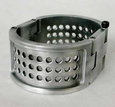 This Metal wrist cuff by Gothic Punk Specialty Hardware has been machined from solid engineering grade Aluminum. It features a perforated design along the rounded sides and has been given a rich antique finish.

The cuff is 1 and 1/4" tall, and closes with a thumb screw.